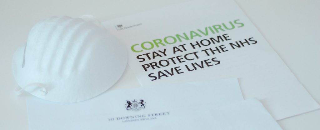 leaflet with writing on it saying coronavirus- stay home and save lives