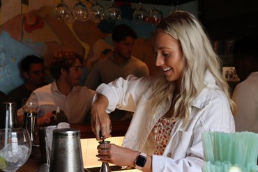 Teagan making cocktails at our summer conference